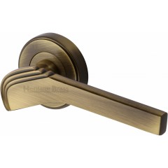 Tiffany Deco Lever Handles on Rose in Antique Brass