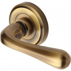 Charlbury Designer Lever Handles on Rose in Antique Brass