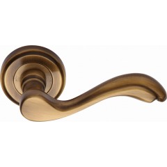 Lisboa Designer Lever Handles on Rose in Antique Brass