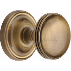 Whitehall Half Reeded Door Knobs in Antique Brass