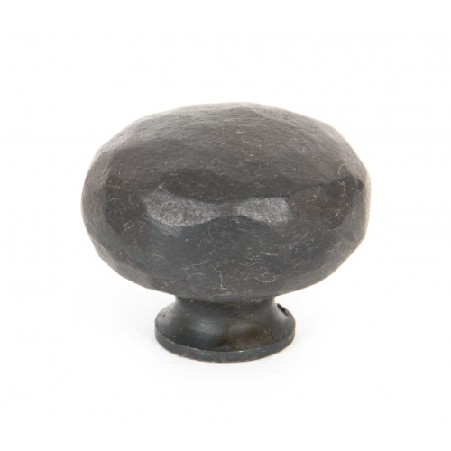 From The Anvil hammered Iron Cupboard Knobs In Beeswax Black Door