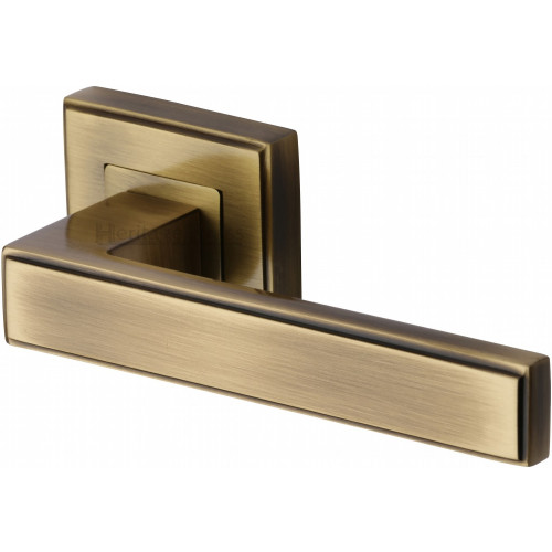 Linear Lever Handles on Square Rose in Antique Brass from Cheshire