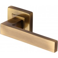 Delta Lever Handles on Square Rose in Antique Brass