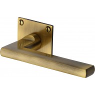 Trident Lever Handles on Slim Square Rose in Antique Brass