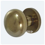 Antique brass unlaquered door knobs on square edge rose