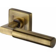 Bauhaus Lever Handles on Square Rose in Antique Brass