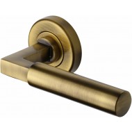 Bauhaus Lever Handles on Rose in Antique Brass