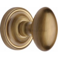 Chelsea Oval Door Knobs in Antique Brass