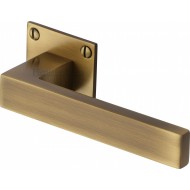 Delta Lever Handles on Slim Square Rose in Antique Brass