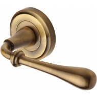 Roma Regency Lever Handles on Rose in Antique Brass