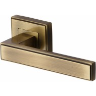 Linear Lever Handles on Square Rose in Antique Brass